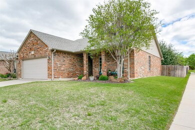 Ranch-style house featuring a front lawn and a gar