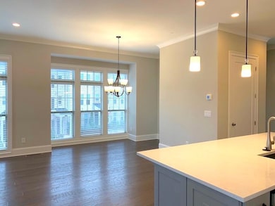 Kitchen with ornamental molding, light countertops