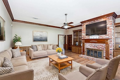 new laminate floors and gorgeous crown molding; the furniture is virtual staging.
