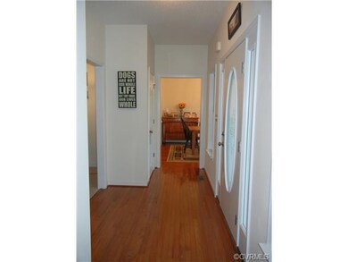Foyer with wood floors and 2 coat closets.