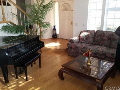 Entry and Living Room With High Ceiling
