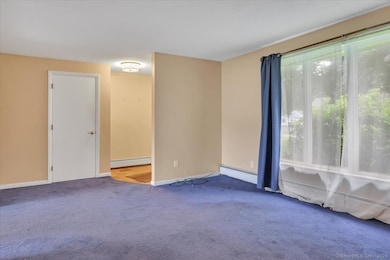 This large front window is a nice feature of this Living Room with a convenient closet.