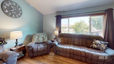 Living room with vaulted ceiling and wood finished floors
