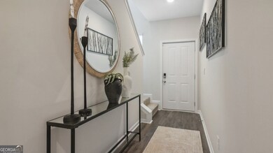 Pearson townhome front entryway foyer long hallway with carpet staircase