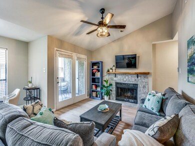 A modern ceiling fan and a wood-burning fireplace 