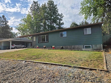 View of front of house featuring a front yard and a carport