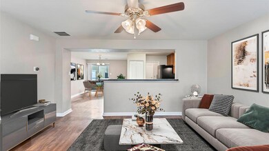 Living area with dark wood finished floors, a cha