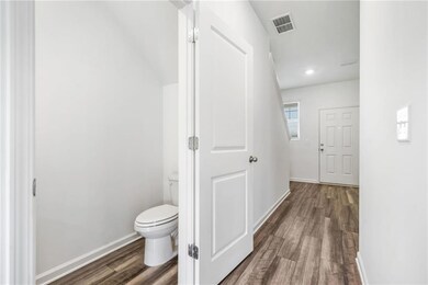 Hall featuring baseboards, wood finished floors, a