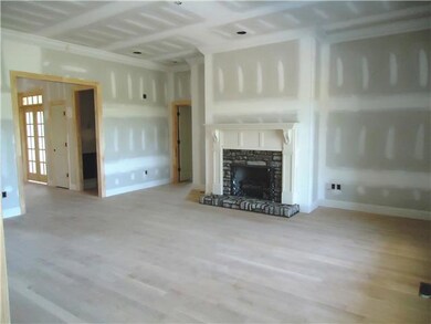The living room has a gas log fireplace, triple windows and recessed lighting.