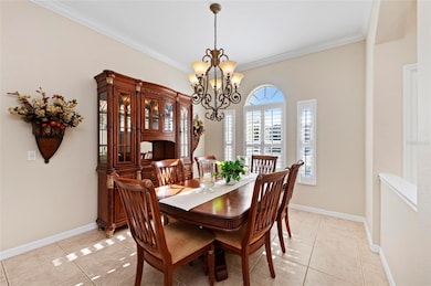 Dining Room features plantation shutters and crown moulding