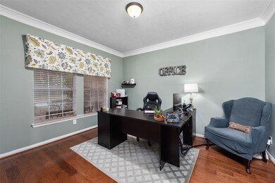 To the left of the foyer is a dedicated home office/study. For days that require focus, the doors can be closed and this space is a quiet workspace. If you prefer to have an open-door policy, there is room for conversational seating. This office overlooks the front porch, with a view out to the landscaped front yard.