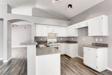 Bright white cabinetry pop against the cool grey w