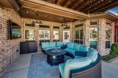 Large seating area under covered porch perfect for enjoying the beautiful outdoors while watching television.