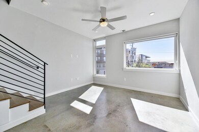 Unfurnished living room featuring concrete floors