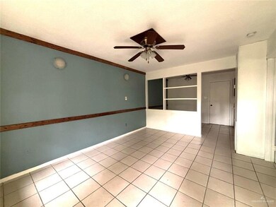Spare room featuring light tile patterned floors, ceiling fan, and a textured ceiling