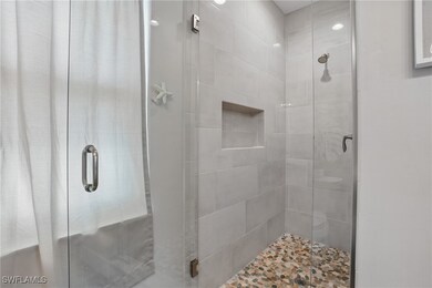 Full bathroom featuring a shower stall