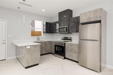 Kitchen featuring appliances with stainless steel finishes and sink