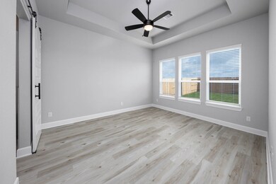 The large primary bedroom with en-suite bathroom i