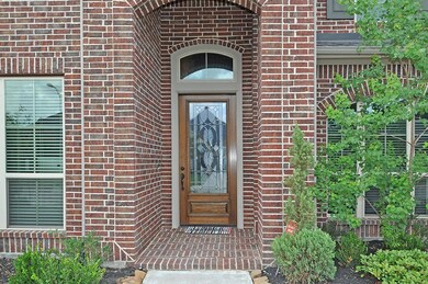Mature landscaping complements an inviting entry.