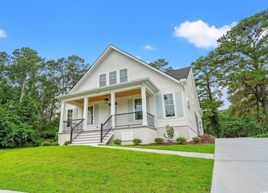 Bungalow featuring covered porch, a front lawn, stairway, and ceiling fan
