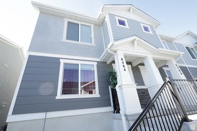 View of front of home featuring a porch, stucco siding, and stone siding