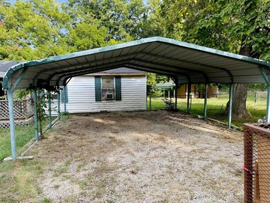 View of vehicle parking featuring a carport