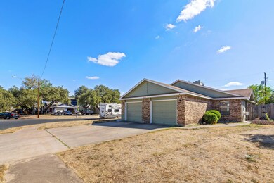 View of property exterior with driveway, brick si