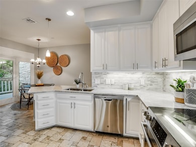 Kitchen featuring white cabinets, visible vents, 