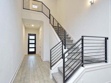 Entrance foyer featuring wood finished floors, a 