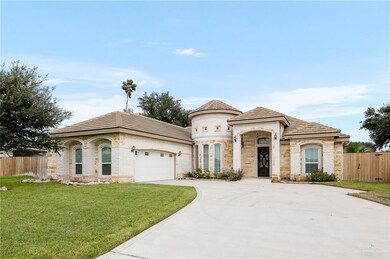 View of front of home with a garage and a front lawn