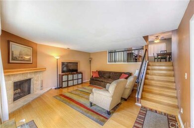 Spacious living room includes wood floors and ston