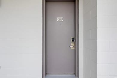 Doorway to property with concrete block siding
