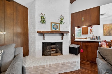 A white brick fireplace offers a cozy yet elegant focal point to the room.