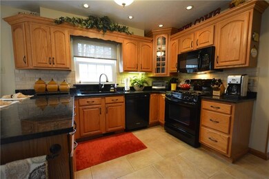 Beautiful ceramic tile floor, oak cabinetry, grani