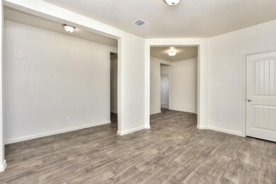 Unfurnished room with baseboards, visible vents, 