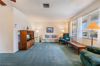 Living area featuring carpet flooring, a textured