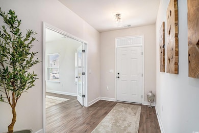 Foyer entrance with wood finished floors and baseboards