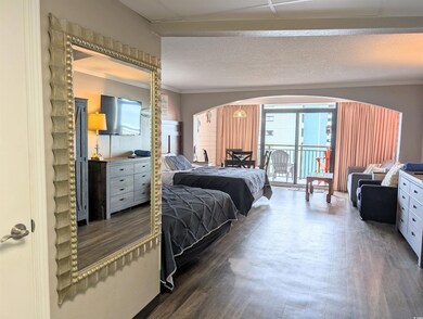 Bedroom with a textured ceiling, crown molding, an