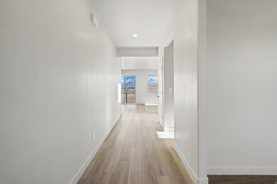 Hallway featuring light wood-type flooring and recessed lighting