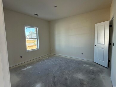 Spare room featuring visible vents, unfinished con