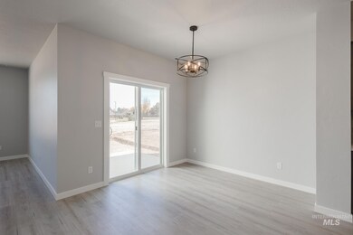 Unfurnished dining area with a chandelier and light wood finished floors