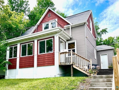 View of front of property featuring roof with shingles and a front yard