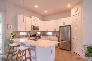 Kitchen featuring stainless steel appliances, lig