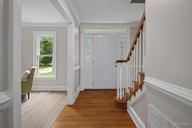 Foyer featuring stairway, light wood-type flooring