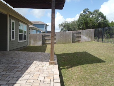 Fenced backyard featuring a patio