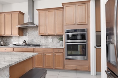 Kitchen featuring wall chimney range hood, applian