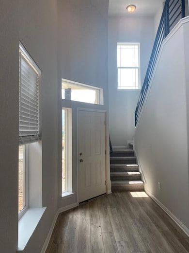 Foyer featuring stairway, wood finished floors, a
