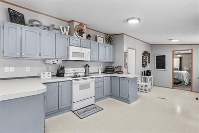 Kitchen featuring ornamental molding, light floors