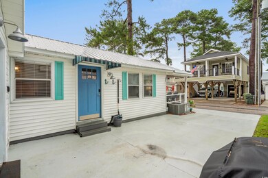 View of front of home featuring entry steps, a metal roof, a ceiling fan, and a patio