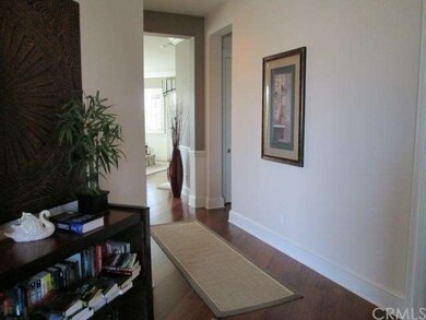 Entrance with rich brown teak-wood floors